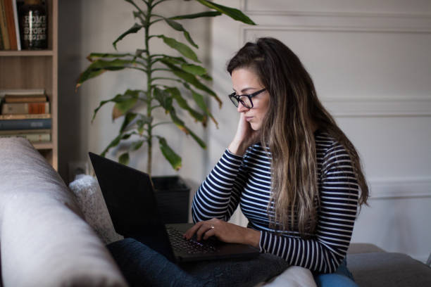 istock Young female freelancer working from home on her laptop computer. 2005187926