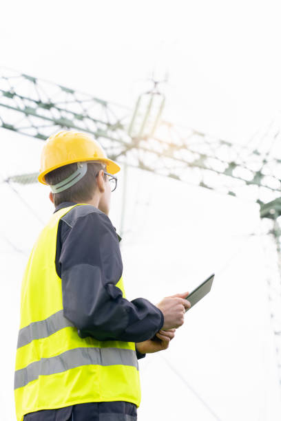 istock Engineer with digital tablet on a background of power line tower 2005197079