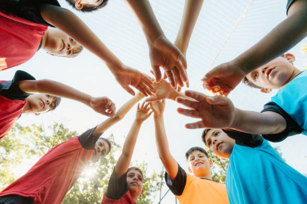 istock A low angle shot capturing a youth soccer team's hands together 2005217193