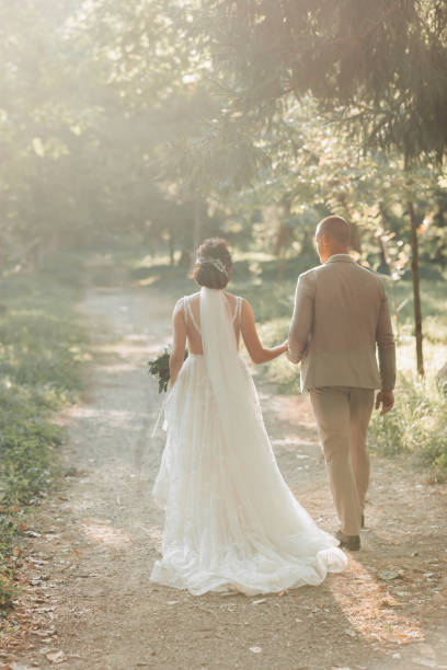 istock The newlyweds are walking in the forest, holding hands. 2005241501