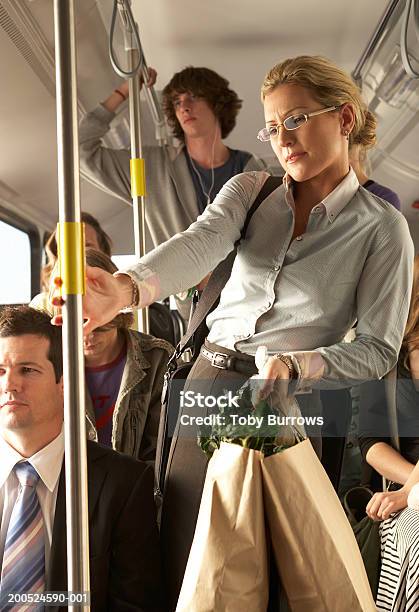 Woman Carrying Shopping Bags On Busy Bus Stock Photo - Download Image Now - Bus, Crowded, Women