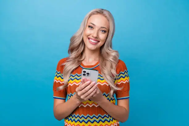 Photo of pretty positive lady wear print shirt communicating instagram twitter telegram facebook isolated blue color background.