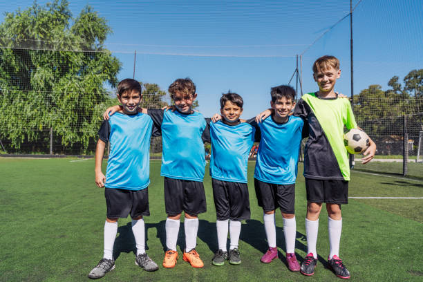 Youth Soccer Team Posing Together on the Field in Uniform stock photo