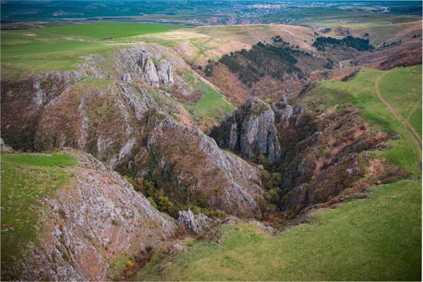 istock Scenic view of grassy rocks overlooking a distant valley 2005262158