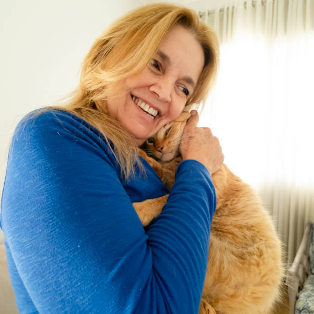 istock Woman and his ginger cat at home. 2005336112
