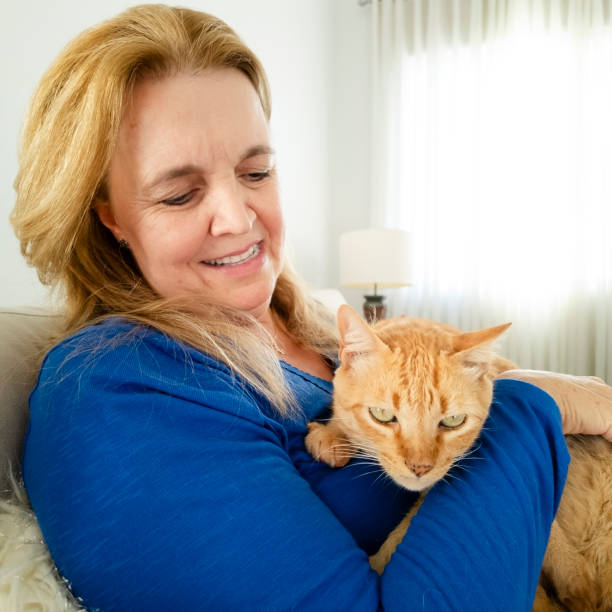 istock Woman and his ginger cat at home. 2005336644