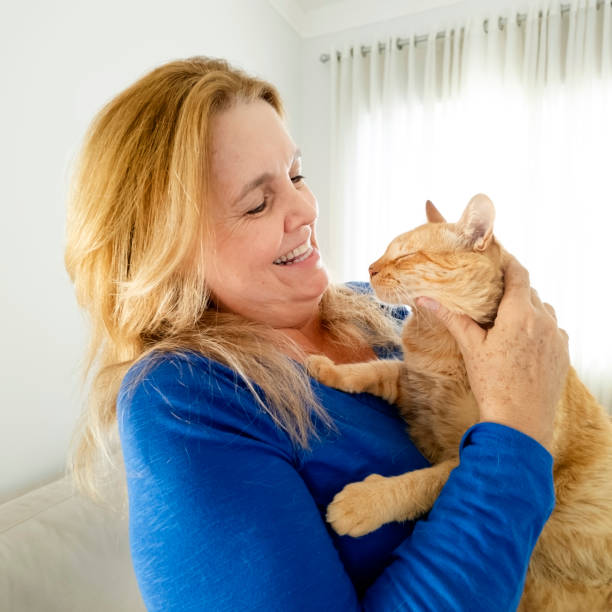istock Woman and his ginger cat at home. 2005336665