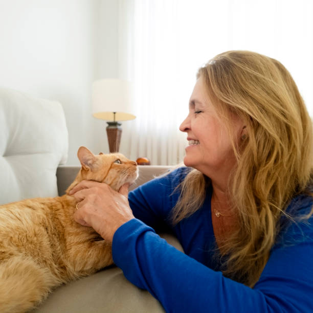 istock Woman and his ginger cat at home. 2005337197