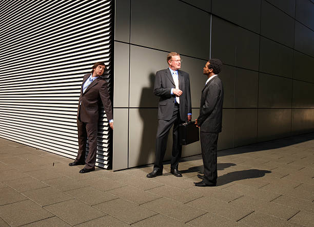 Businessman eavesdropping on conversation at street corner  eavesdropping stock pictures, royalty-free photos & images