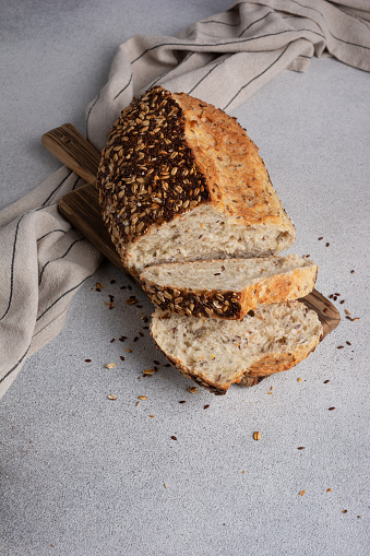 Organic homemade whole grain bread on wooden cutting board. Delicious brown bread made from whole grain flour for a healthy diet