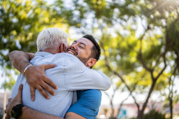 istock Father and son embracing on public park 2005357835