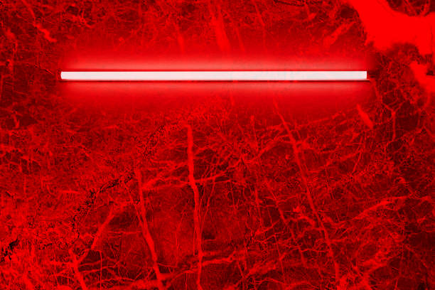 red neon light bulbs on marble wall. Background texture of empty old marble wall with glowing red neon lamps.