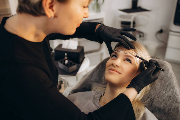 istock Cosmetician making measuring with ruler and getting ready to apply makeup to a client. Closeup shot 2005376023