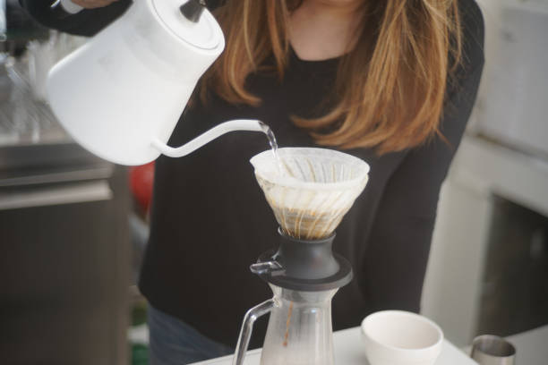 istock The girl prepared water in the machine for make coffee drip process 2005379229
