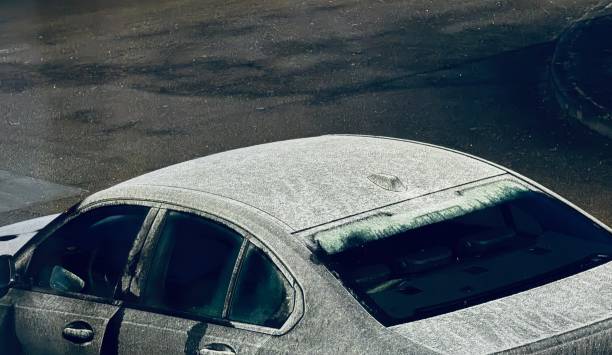 Marbach, Germany - December 12th - 2023: BMW Car in a bitterly cold night on the road, with light icing.