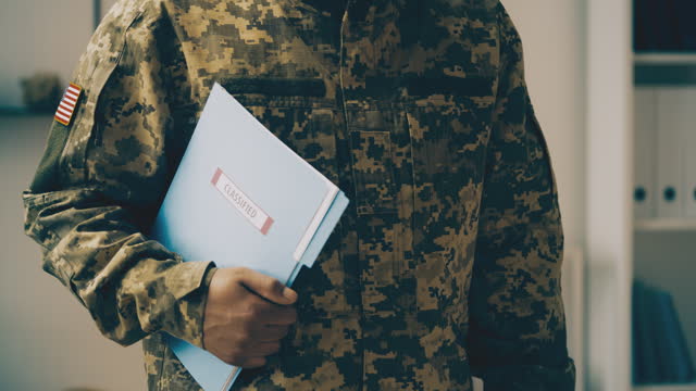 USA intelligence officer holding folder with classified document, secret data