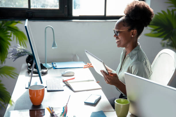 istock Business woman side portrait at workplace 2005420958