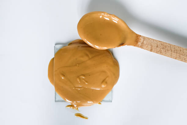 istock Peanut butter. Wooden spoon. 2005421474