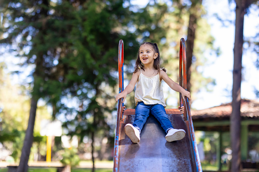 Portrait of girl playing on a slippery slope