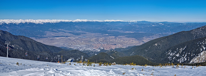 Panoramic view to the beautiful town of Bansko seen at the bottom of the Pirin mountain peaks
