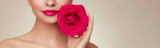 istock Beautiful model with a rose flower 2005435856