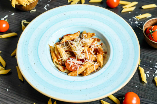 istock Plate of Pasta With Tomatoes and Parmesan Cheese 2005437987