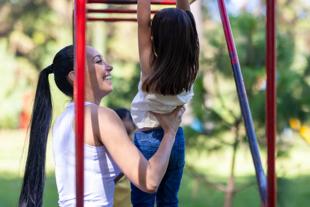 istock Young mum helping her daughter on the handrail 2005439508