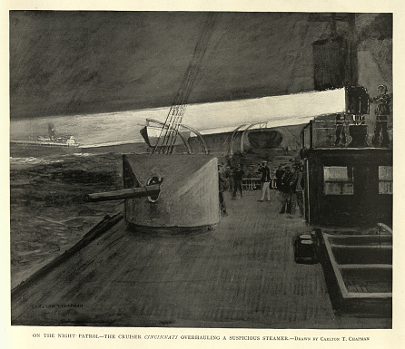 Vintage picture, Military history, United States Navy warship on night patrol,Searchlight, USS Cincinnati overhauling a suspicious steamer, Spanish–American War. 1890s 19th Century