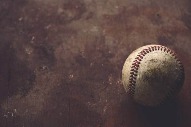 istock Old vintage baseball ball on brown background 2005456031