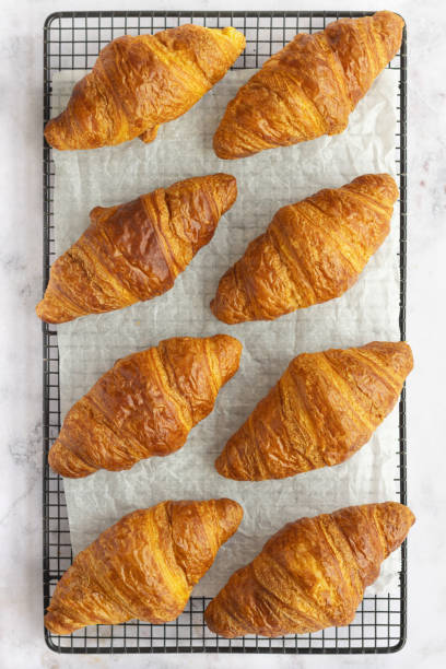 istock Freshly baked butter croissants on wire rack. Close up. 2005476724
