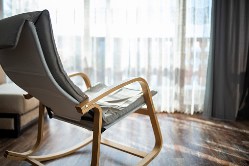 Modern wooden rocking chair in apartament.