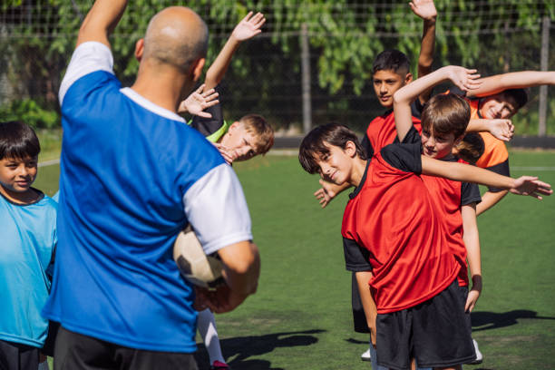 istock Youth Soccer Team Practicing with Coach on Sunny Day 2005478653