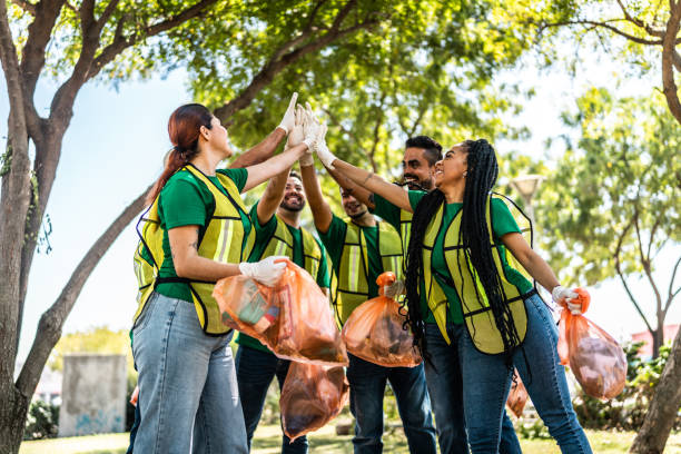 istock Recyclers doing high-five after cleaning the public park 2005479409