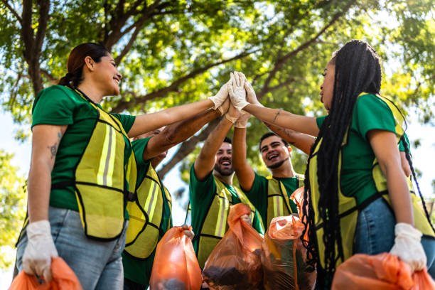 istock Recyclers doing high-five after cleaning the public park 2005479411