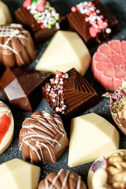 istock Close Up of Assorted Chocolates in Various Flavors and Shapes 2005485988