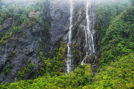 Experience the enchanting beauty of Franz Josef with cascading waterfalls amidst pristine temperate rainforest in New Zealand. A natural paradise awaiting exploration and discovery.