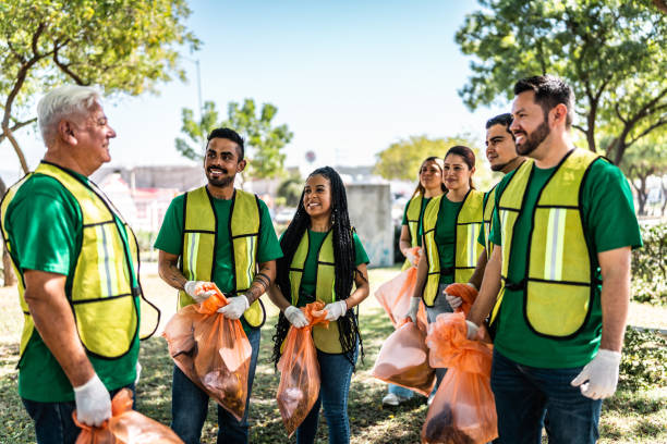 istock Recyclers talking and cleaning the public park 2005497780
