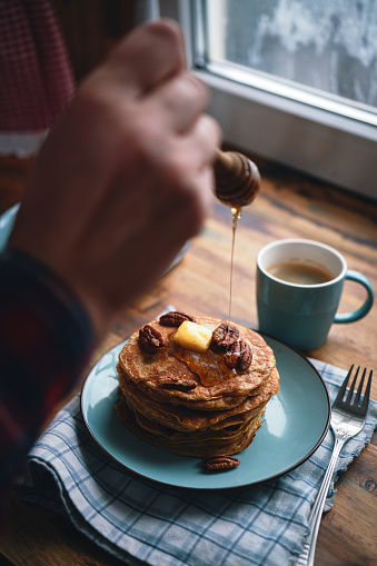 Stack of Sweet Potato Pancakes with Butter and Pecan Nuts