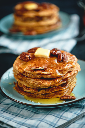 Stack of Sweet Potato Pancakes with Butter and Pecan Nuts