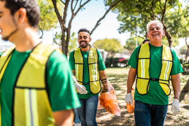 istock Recyclers collecting trash from the public park 2005503699