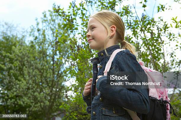 Girl Carrying Backpack Outdoors Smiling Side View Stock Photo - Download Image Now