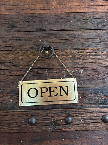 Open sign on cafe hang on door at entrance text