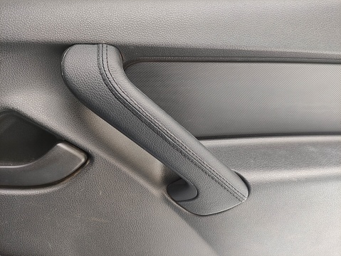 A leather covered car interior handle