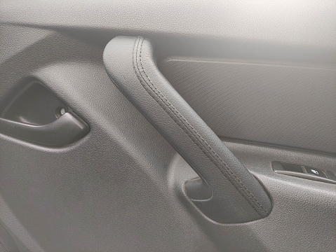 A leather covered car interior handle