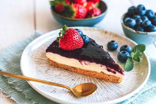 Delicious homemade no bake cheesecake with fresh blueberry and strawberry.