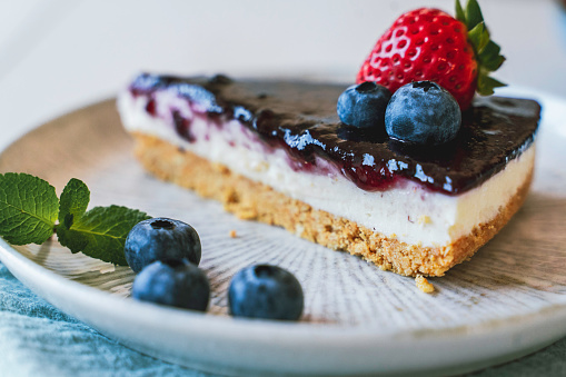 Overhead view of a blueberry tart decorated with fresh mint leaves