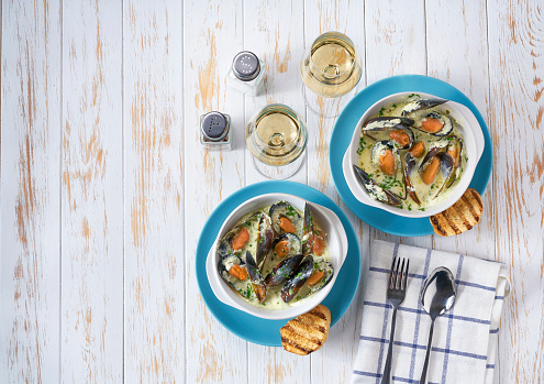Mussels in cream sauce with white wine on a wooden table copy space for text. Healthy Food Concept. Omega -3