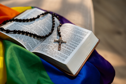 Holy Bible on LGBT rainbow flag