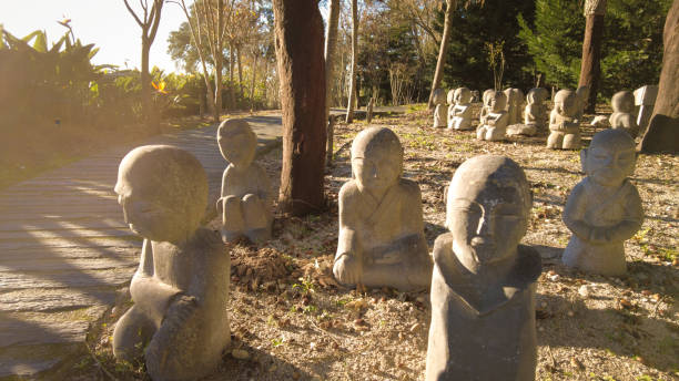 Monk stone figures in Bacalhoa Buddha Eden oriental garden in Portugal