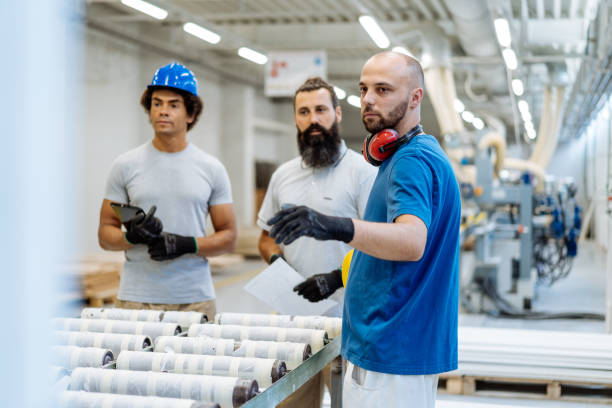istock Engineers near production line talking to blue collar worker 2005637200